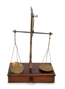 AVERY antique gold scales on a single drawer mahogany base, 19th century, 38cm high, 25cm wide, 13cm deep.