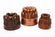 Three antique copper jelly moulds, 19th century, the largest 13cm high, 15cm diameter.