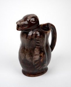 A brown glazed pottery bear wine jug, unknown age and origin, 21.5cm high.
