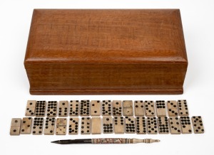 88 · Antique whalebone dominoes, antique whalebone stylus with hand-painted finish, housed in a Queensland silky oak box, 19th and 20th century, the box 26cm wide.