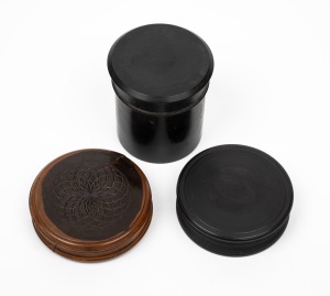 An antique lignum vitae box, together with two antique ebony boxes, 18th/19th century, the largest 8cm diameter.