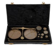 Brass balance scales and weights in a black velvet lined case, 20th century, ​​​​​​​the case 28cm wide.