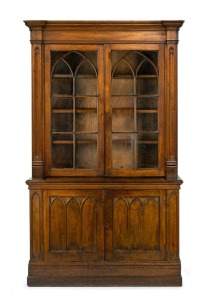 A rare and early Colonial Australian cedar Gothic Revival two door library bookcase with applied tracery moulded decoration and astragal glazed upper door flanked by recessed Gothic full length pilasters, full cedar construction, original brass fittings a