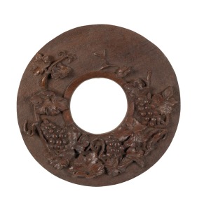 An antique jarrah folk art circular picture frame with carved grape decoration, Western Australian origin, 19th/20th century, 39cm diameter, (internal 14cm diameter).