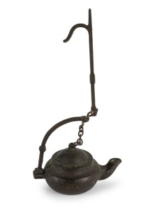 An antique cast bronze whale oil "Betty" lamp, mid 19th century, ​​​​​​​10cm high, 10cm wide.