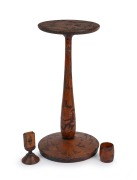 An Australian huon pine pokerwork smoker's stand with accompanying cigarette holder and matchbox stand, profusely decorated with parrots and floral motif, early 20th century, (3 items), each piece signed with the initials "E. A.", 50cm high, 23cm diameter
