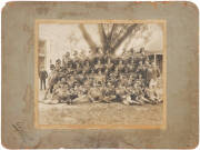 c1890-1900 [AUSTRALIAN SOLDIERS IN FULL DRESS UNIFORM], toned silver gelatin photograph, with printed studio line "Charlemont, 492 George St, Sydney" laid down on original backing, 23.3x28.9cm. [Some surface loss affecting the soldier in 1st row, lower ri