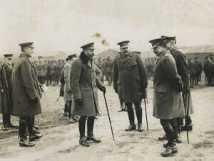 "THE KING [GEORGE] INSPECTS THE AUSTRALIAN IMPERIAL FORCES IN ENGLAND", c1914-18 silver gelatin photograph, typed caption on slip and photographer's stamp verso, 14.5x19.4cm. [two small stains to centre]. Caption includes "The King chatting to the staff o