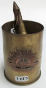 WW1 TRENCH ART: collection of trench art shell cases. 75mm Japanese brass shell with Australian Commonwealth Military Forces emblem; 18 Pounder MKII brass shell jar with lid, dated 1916; 4.5-inch Howitzer brass shell ash tray, dated 1915;.50 caliber M2 ma