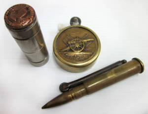 WW2 TRENCH ART: assortment of 3 Second World War trench art lighters. Brass .30 caliber round lighter with removable tip; attractive circular brass lighter with a cannon on the observe side and soldier and wife on the reverse side; small polished tube wit