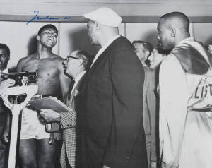 MUHAMMAD ALI, signed b/w photograph of Ali at weigh-in with Sonny Liston, size 51x41cm. With CoA.