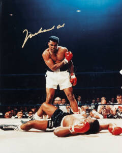 MUHAMMAD ALI, signed colour photograph of Ali standing over Sonny Liston, size 28x35cm. With CoA.