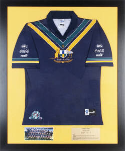 1999 INTERNATIONAL RULES - AUSTRALIA v IRELAND: Australian jumper used in 1999 match at Football Park in Adelaide (ending in a draw), window mounted, framed & glazed, overall 90x112cm.