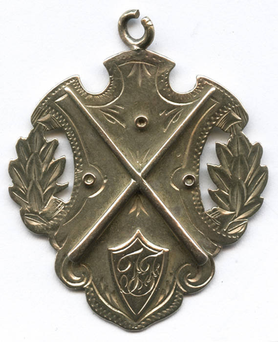 BILLIARDS MEDAL, 9ct gold fob/medal with Billiards cues & initials "TF" on front, engraved on reverse "RSA Billiard Championship, 1917, T.Foulkes". Weight 8.86 grams.
