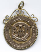 WRESTLING MEDAL, 9ct gold fob/medal with "Wide Bay & Burnett Centre/ Maryborough" on front, engraved on reverse "Dist Wrestling C'ship, 1928, Bantam, T.A.Miller". Weight 11.24 grams.