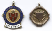 FOOTBALL MEDALS: 9ct gold fob/medal engraved on reverse "North Lancs & Dist Football League, Div.1 Winners 1933/4"; plus 9ct gold & enamel fob/medal "Northern Amateur Football League/ 1936-1937", engraved on reverse with initials "HJ". Total weight 12.34