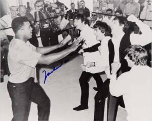 MUHAMMAD ALI & THE BEATLES, photograph of Ali clowning around with The Beatles, signed "Muhammad Ali", size 51x40cm. With CoA No.0551.