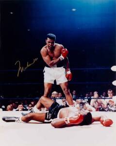 MUHAMMAD ALI, signed colour photograph of Ali standing over Sonny Liston, size 41x51cm. With CoA No.0471.