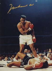 MUHAMMAD ALI, signed colour photograph of Ali standing over Sonny Liston, size 28x35cm. With CoA No.0545.
