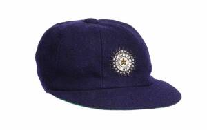 KAPIL DEV'S INDIAN TEST CAP, navy blue with wire embroidered Indian logo on front, signed inside by Kapil Dev and dated "2000". G/VG condition. [Kapil Dev played 131 Tests & 225 ODIs 1978-94, and captained the Indian cricket team which won the 1983 Cricke