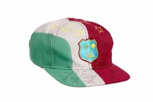WEST INDIES CRICKET CAP, baseball-style, with embroidered West Indies logo on front, with 4 signatures on brim including Roger Harper. Good match-used condition.
