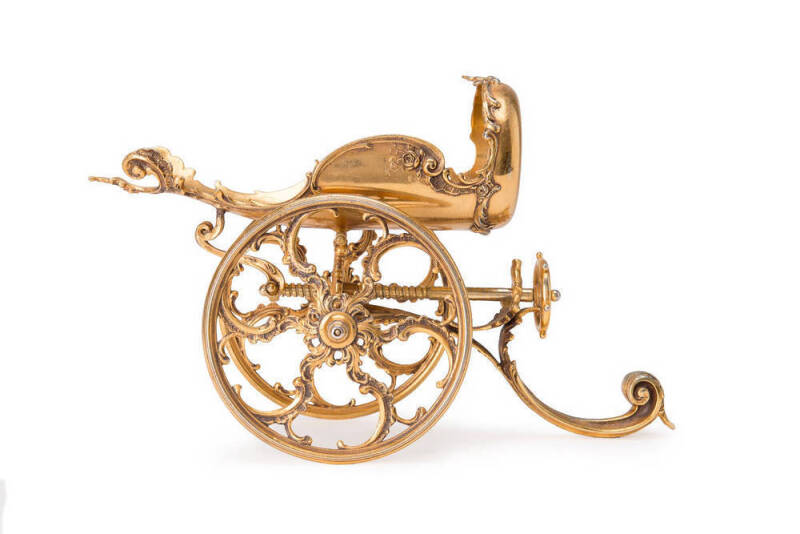 Wine bottle holder in the form of an ornate cannon. Gilt finish, French 19th century. 23cm. 