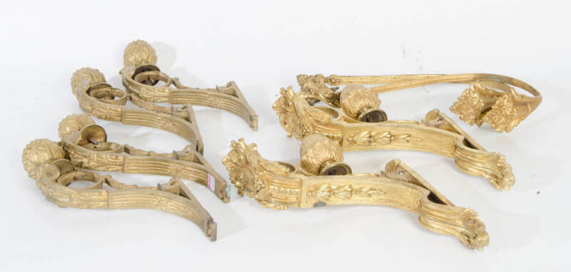 French gilt metal curtain rod brackets with fruit finials (three pairs; plus a pair of gilt metal curtain holders). 