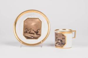 A Vienna coffee can and saucer, 18th century. Finely painted with small chickens and cockerels in sepia colours on a cream and gold ground