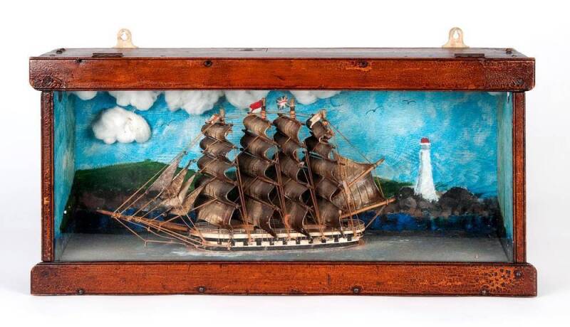 A Victorian diorama, English 19th century; of a four masted ship under sail in glass case. 31cm high, 64cm wide.