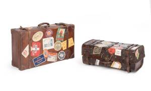 Vintage travel cases adorned with hotel and transit labels. (2 cases)
