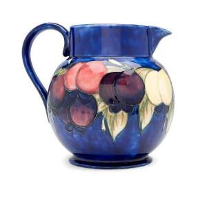 MOORCROFT: Wisteria pattern pottery water jug on blue ground, c1930s. Height 20cm, width 22cm&nbsp;