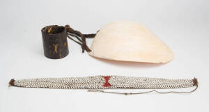 A Bailer Shell Ornament, Belt and Tortoise Shell Armband,&nbsp;Southern Highlands, Papua New Guinea (early-mid 20th century), bailer shell, binding, cowry shells and tortoise shell, 27cm; 53cm and 9cm long (3)