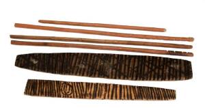 Group of Aboriginal artefacts, two firesticks, bullroarer and poker work stick. Varying sizes. (6 items).