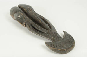 FOOD HOOK: Papua New Guinea origin, carved wood with shell inlaid eyes, mid 20th century. 70cm