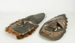 MASKS: Two Papua New Guinea origin masks, carved wood, shell, tusk, natural fibre & ochre finish, mid to late 20th century. 75cm each