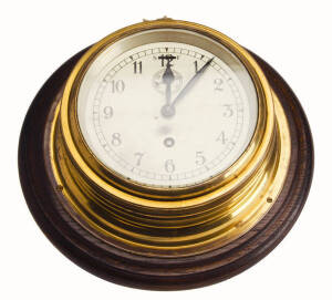 Oak mounted brass ships clock, 26cm diameter.