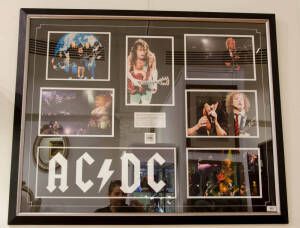 AC/DC, display comprising photograph signed by Brian Johnson, Angus Young, Malcolm Young, Cliff Williams & Phil Rudd, window mounted with 5 other photographs, limited edition 1/100, framed & glazed, overall 110x90cm. With CoA.