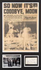 NEIL ARMSTRONG (1930-2012, first person to walk on the moon), display comprising signature on piece, window mounted with front page from 'The Sun' dated 22 July 1969, and photo of the Astronauts visiting Sydney, framed & glazed, overall 46x68cm.