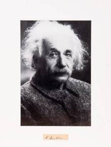 ALBERT EINSTEIN (1879-1955, the father of modern physics & one of the most prolific intellects in human history), display comprising signature on piece, window mounted with picture, overall 41x55cm.
