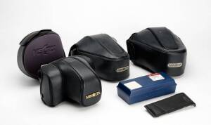 MINOLTA (Japan): A group of Minolta accessories. Including camera backs for 5000 and 7000, camera cases for various Minolta cameras. New old stock. Additionally a box of Minolta flash units (21), ranging from the simpler type to several program AF 2800 un