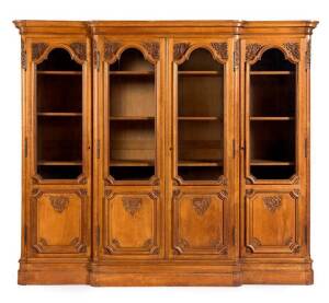 French oak 4 door bookcase with carved panel and glazed doors; height 195cm, width 233cm, depth 52cm
