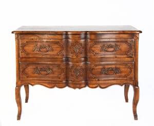 A French Louis XVI style serpentine top fruitwood commode supported on four carved cabriole legs. 83cm high, 107cm wide and 58cm deep