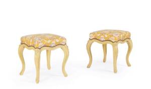 A pair of Louis XVI yellow painted stools, French, 18th century, upholstered in cotton printed chintz supported on elaborately carved cabriole legs. 46cm high, 46cm square. Provenance: Christie's 17/4/2013 lot 171, Private Collection from St Tropez
