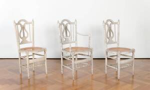 Three matching cream painted caned chairs, French early 19th century