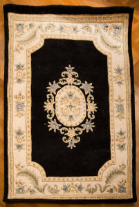 RUG: Pure wool rug, Notredame design in black and ivory colours. 155 x 225cm