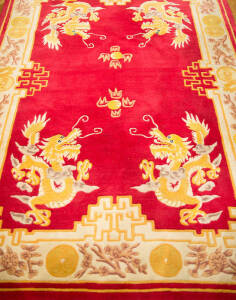 RUG: Chinese red and gold dragon patterned carved rug. 237 x 159cm