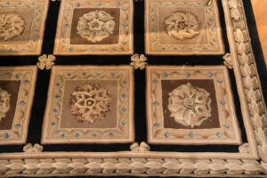 RUG: European style black and gold floral style rug. 250 x 160cm.