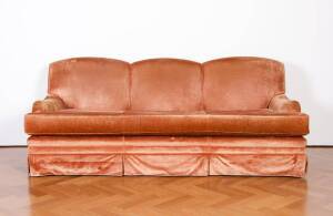 A large three seater settee covered in chestnut brown velvet