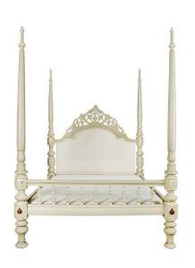 A beige painted four poster bed
