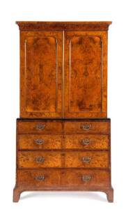 LINEN PRESS: George II oyster veneer walnut with brass handles, c1720s. Height 206cm, width 113cm, depth 53cm